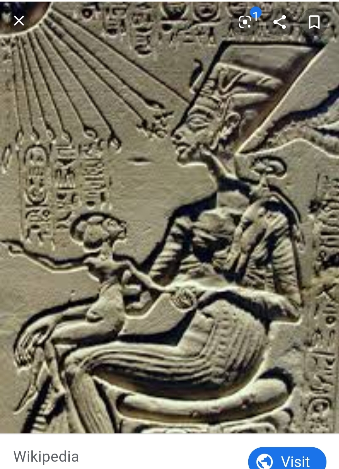 Meketaten situated on her mother, Nefertiti's lap