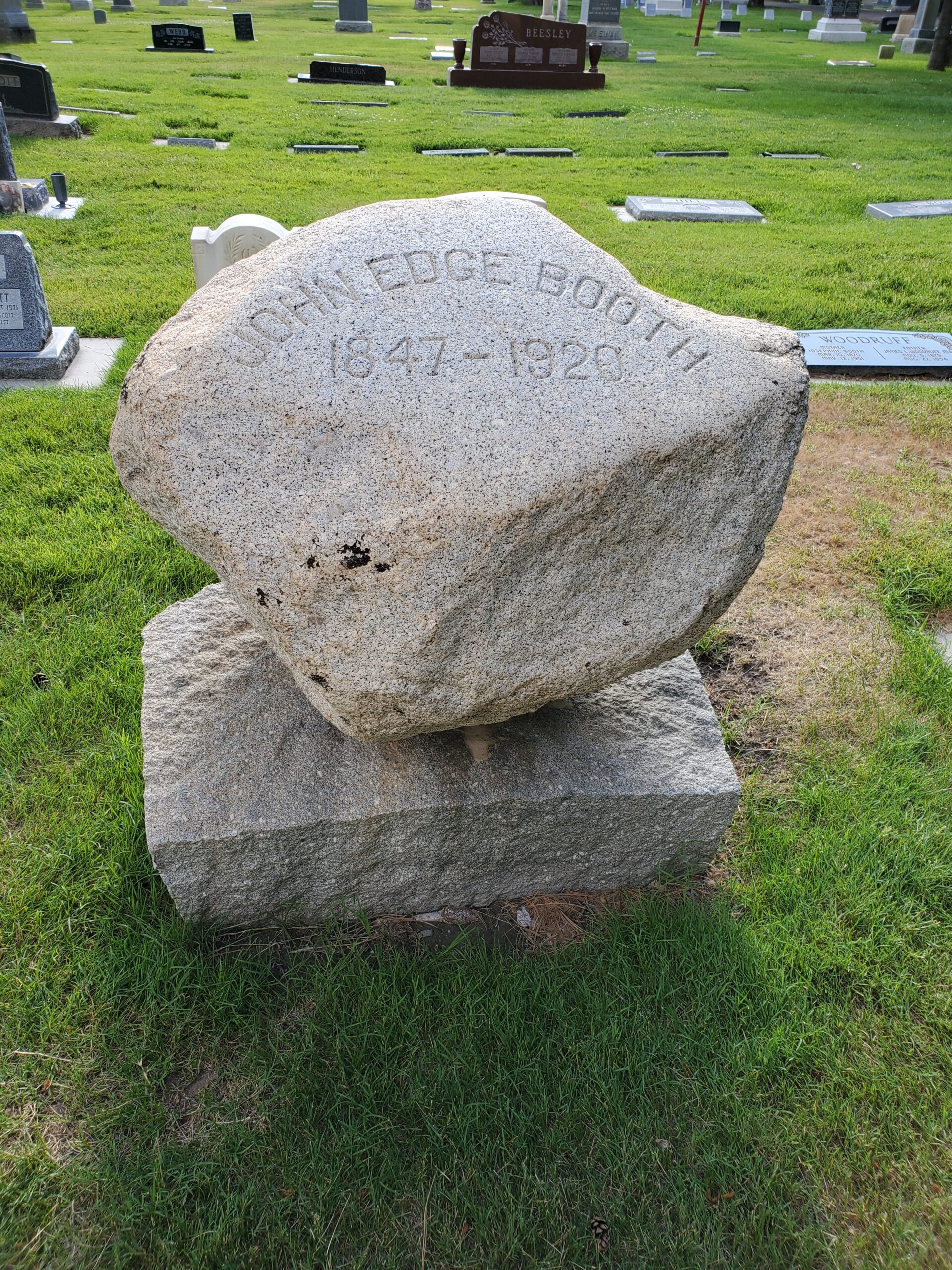 This grave marker is a simple boulder engraved with a name
