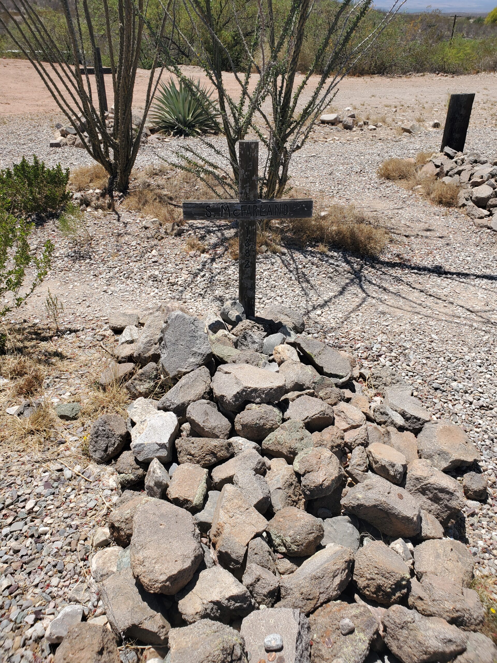 This simple cross grave marker is labeled as one "S McFarland"